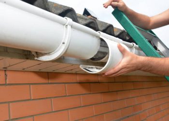 Roof gutter repair. Guttering repair. Roofer contractor repair house rain gutter pipeline.